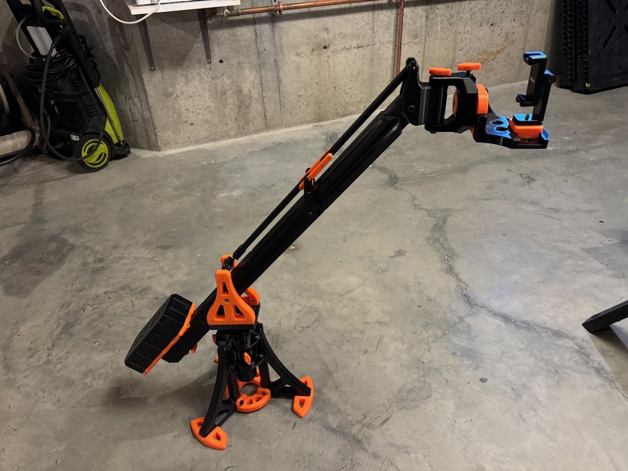 a photograph of a black and orange 3d printed photography jib.