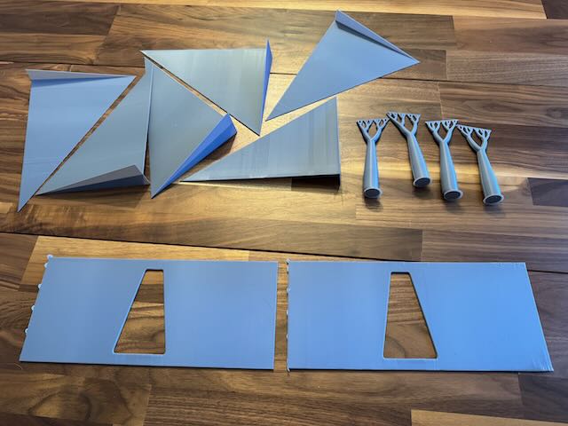 six triangular fins, four fractal tree supports, and two final plates. the fins easily contain as much material as the plates they supported.